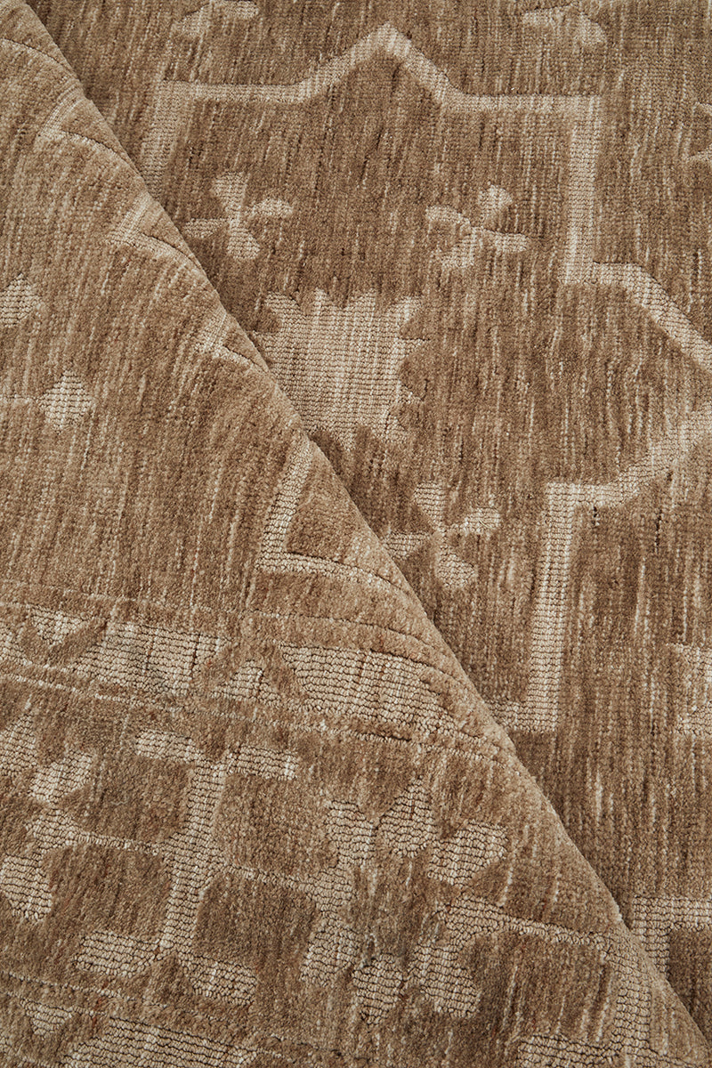 Warm almond floor rug with tonal pattern